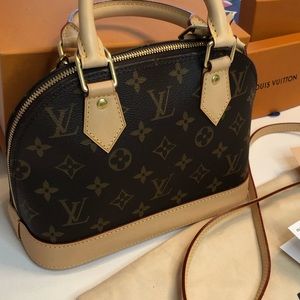 Louis Vuitton Alma BB coated canvas bag with detachable strap & golden lock.